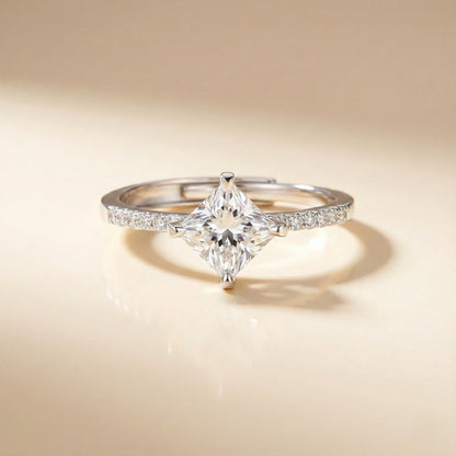 Diamond ring held in a hand with a blurred background