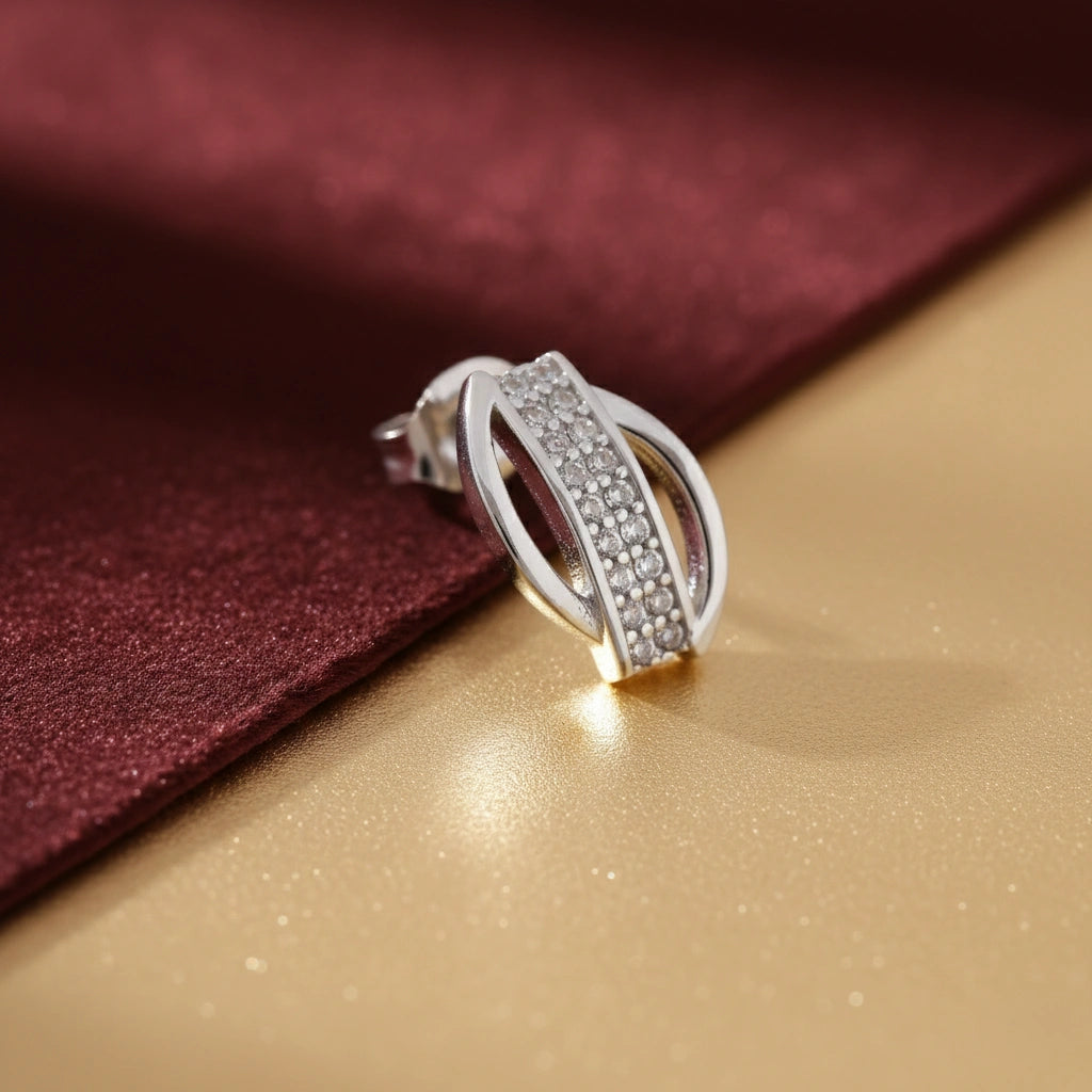 Silver ring with gemstones on a gold and red fabric background