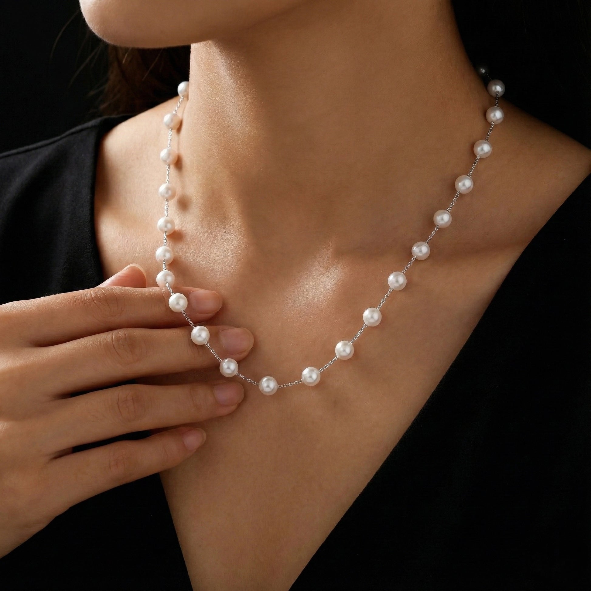 Pearl necklace being worn by a person with a blurred background