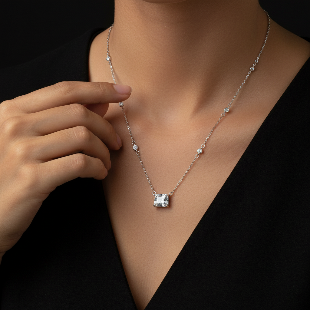 Silver necklace with a pendant on a black background