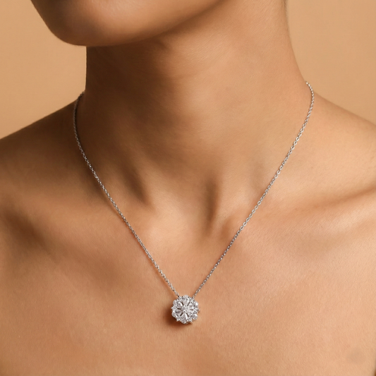 Silver necklace with a diamond pendant on a model against a beige background