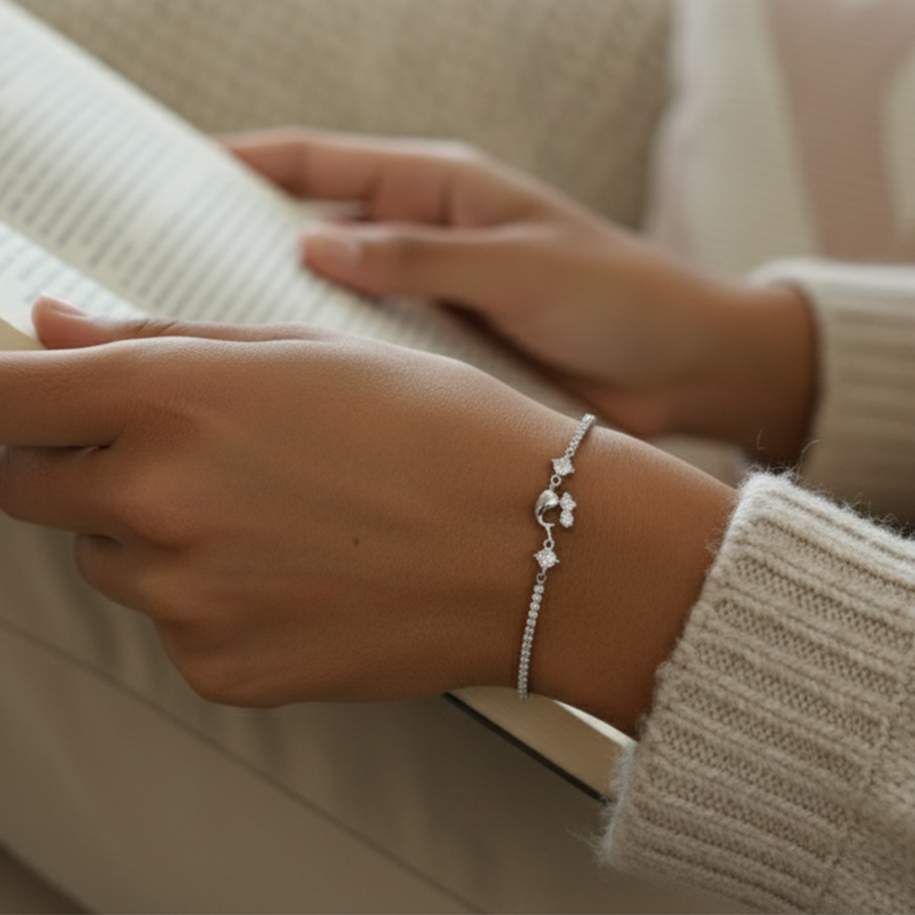 Close-up of a person's wrist wearing a silver bracelet with a neutral background