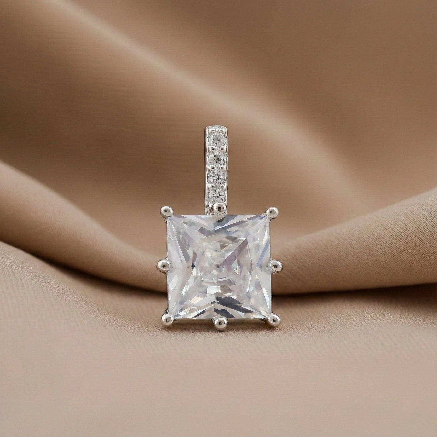 Diamond pendant on a beige fabric background