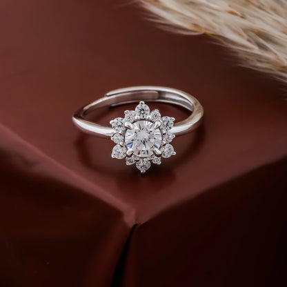 Silver ring with a diamond on a brown fabric background