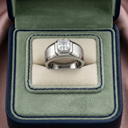Silver ring with a diamond in a green velvet box