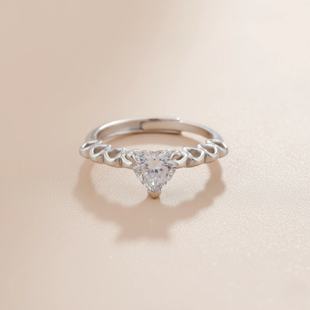 Silver ring with a diamond on a beige background