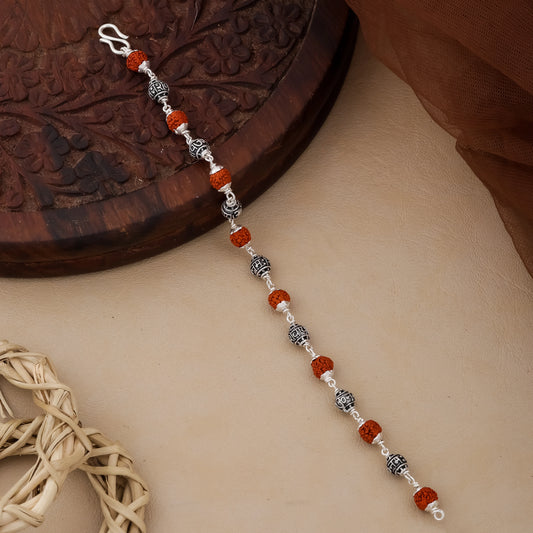 Beaded keychain with red and silver beads on a textured surface