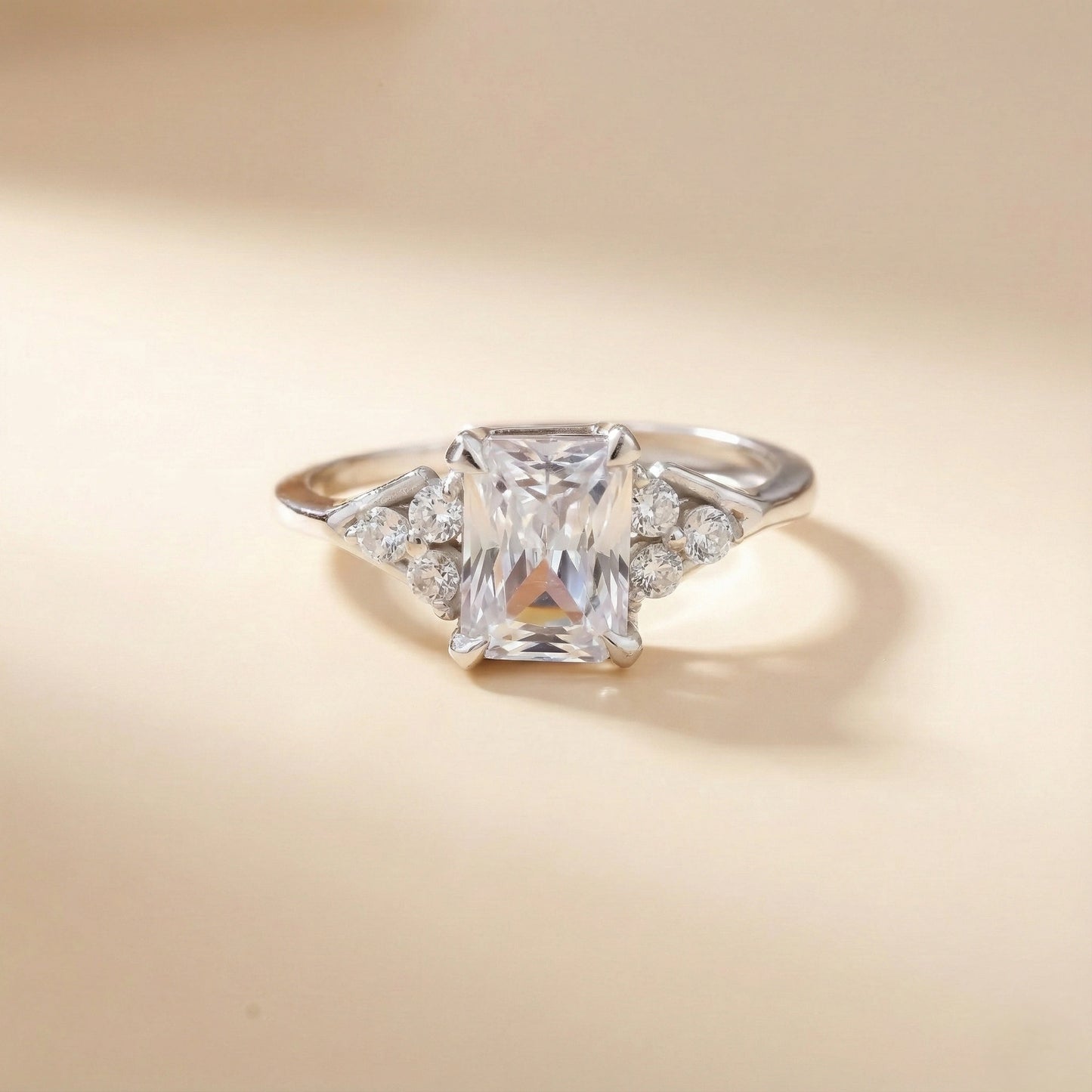 Diamond ring with a square-cut gemstone on a beige background
