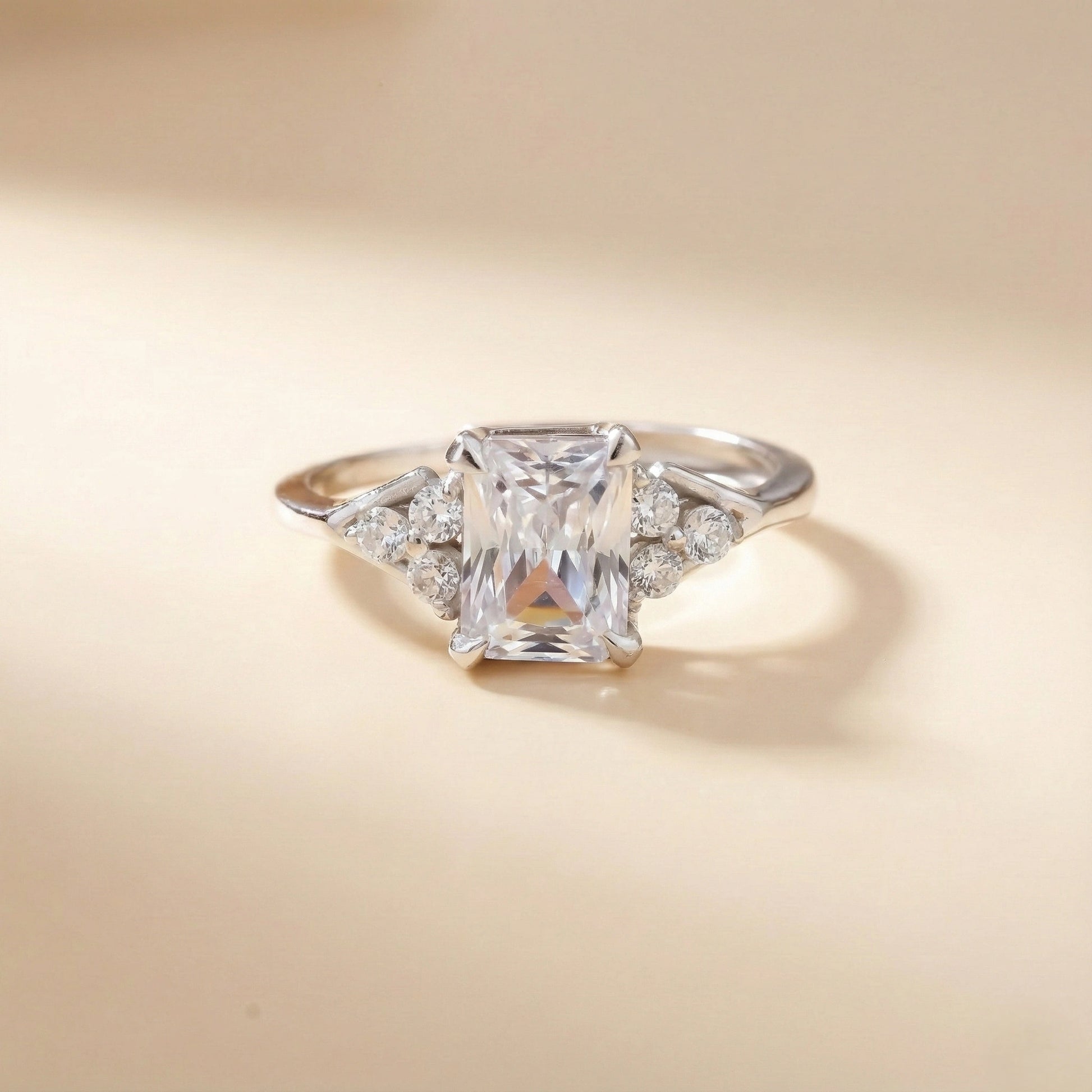 Diamond ring with a square-cut gemstone on a beige background