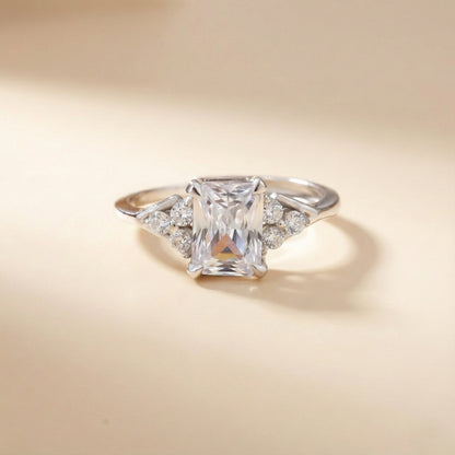 Diamond ring with a square-cut gemstone on a beige background