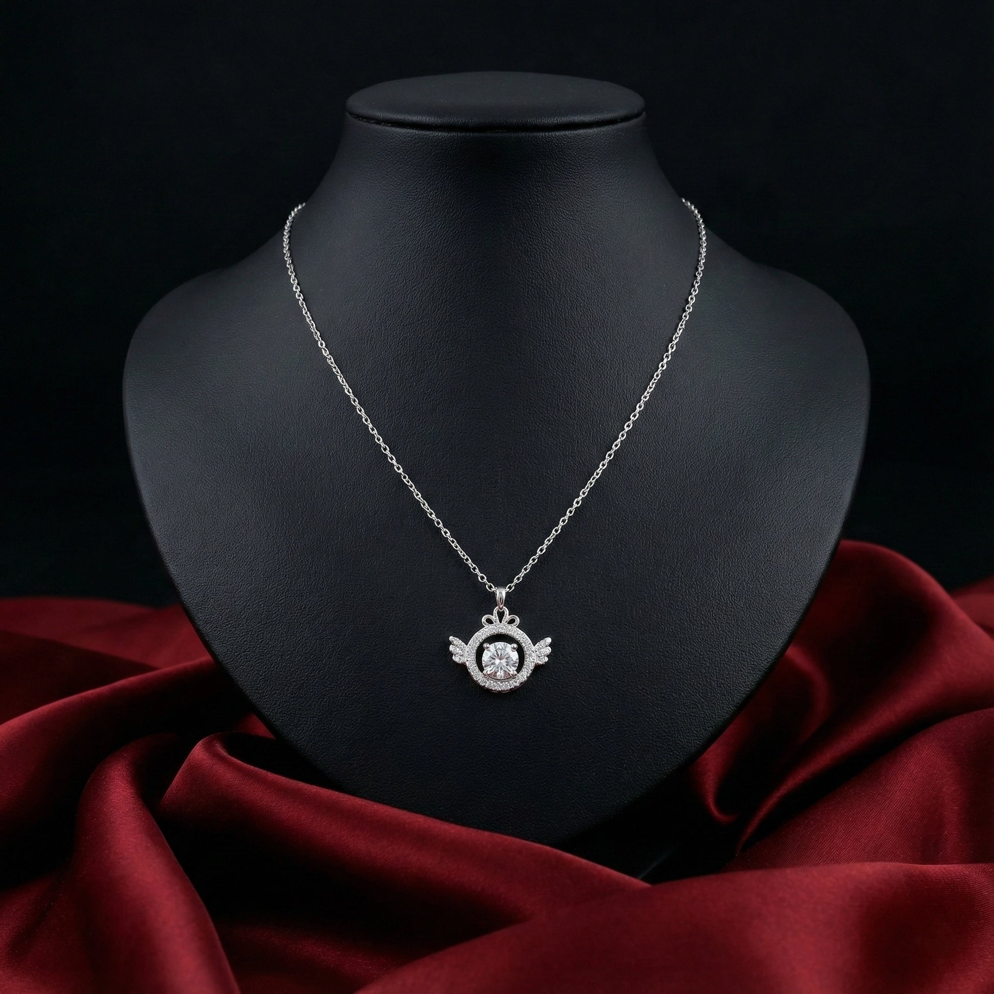 Silver necklace with a pendant on a black mannequin bust against a dark background