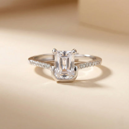Silver ring with a large diamond on a beige background