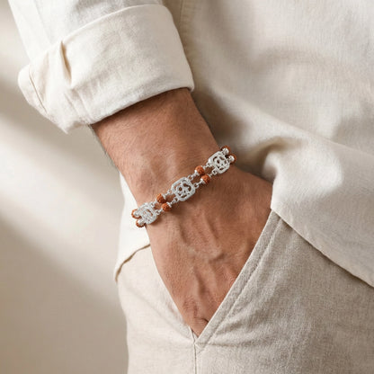 Close-up of a wrist wearing a bracelet with a neutral background