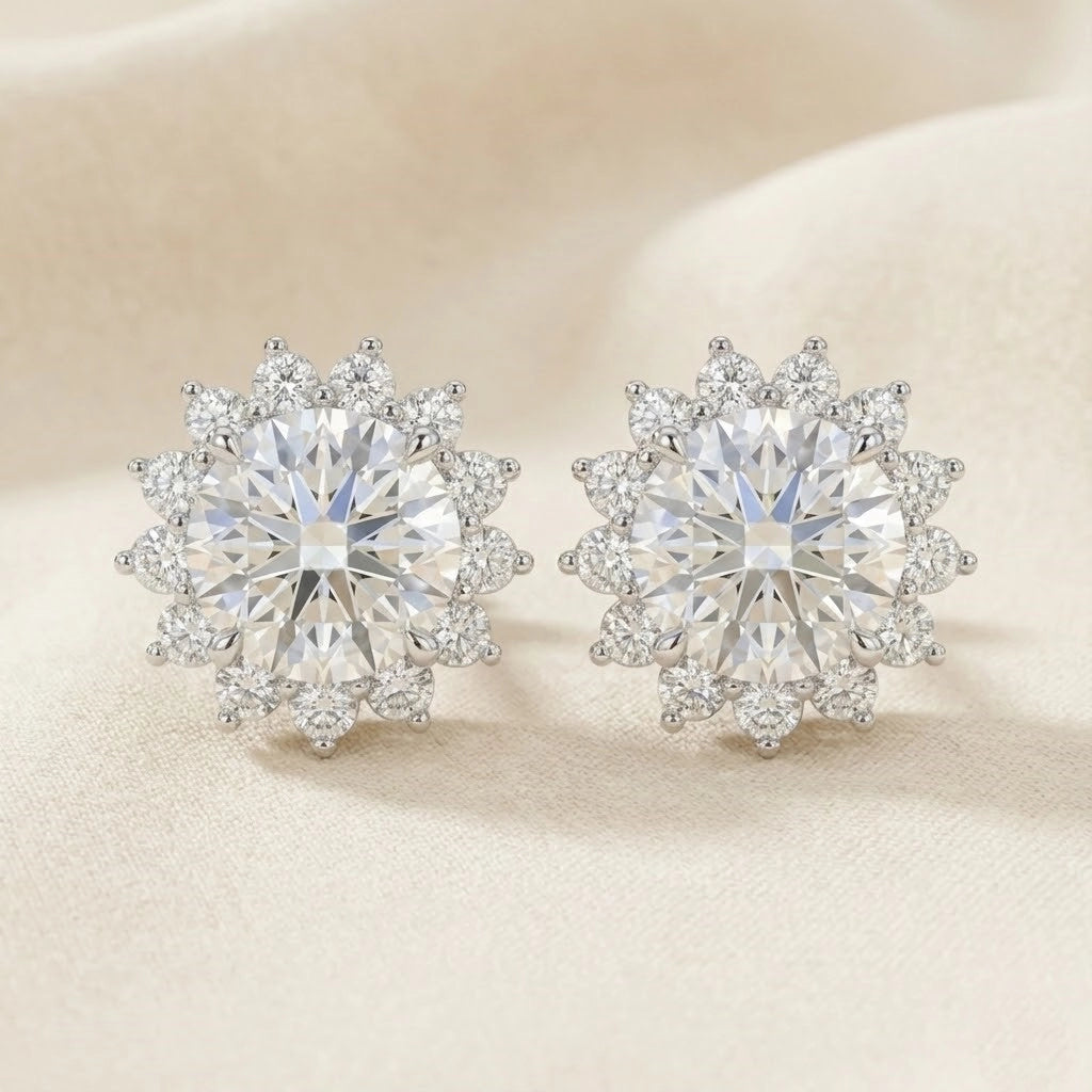 Pair of diamond earrings on a beige background