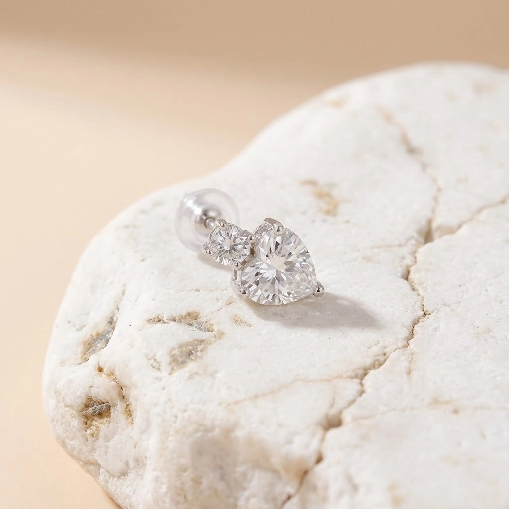 Diamond earrings on a textured stone surface