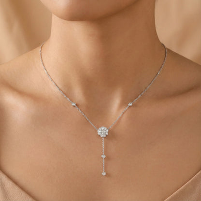 Silver necklace with a pendant on a model against a beige background