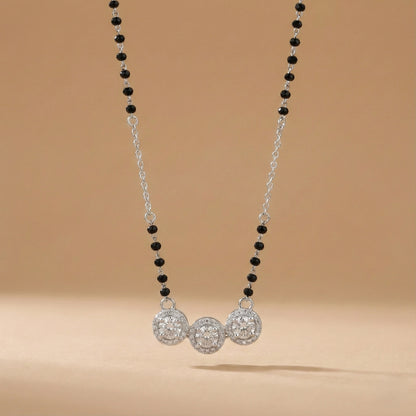 Necklace with black and silver beads on a beige background