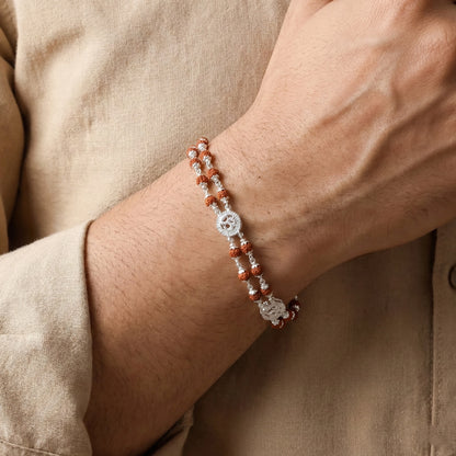 Close-up of a wrist wearing a beaded bracelet with a neutral background