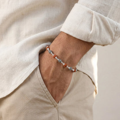 Person wearing a bracelet with a neutral background