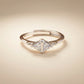Diamond ring with a triangular cut gemstone on a beige background