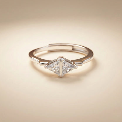 Diamond ring with a triangular cut gemstone on a beige background