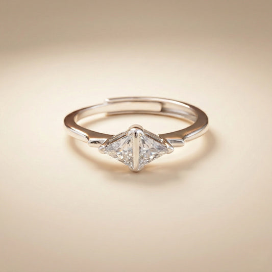 Diamond ring with a triangular cut gemstone on a beige background