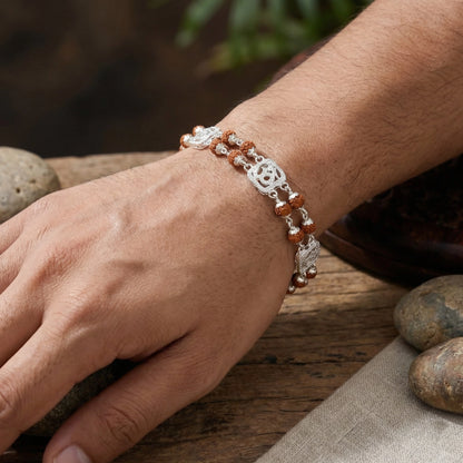 Close-up of a hand wearing a bracelet with a natural background