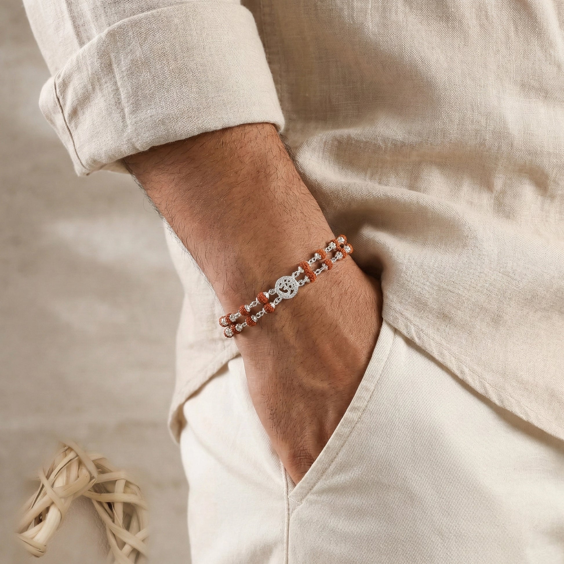 Person wearing a bracelet with a neutral background