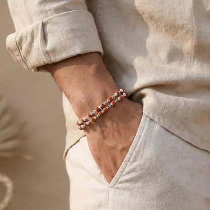 Close-up of a person wearing a bracelet with a neutral background