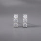 Pair of diamond stud earrings on a gray background