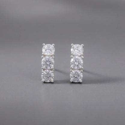 Pair of diamond stud earrings on a gray background