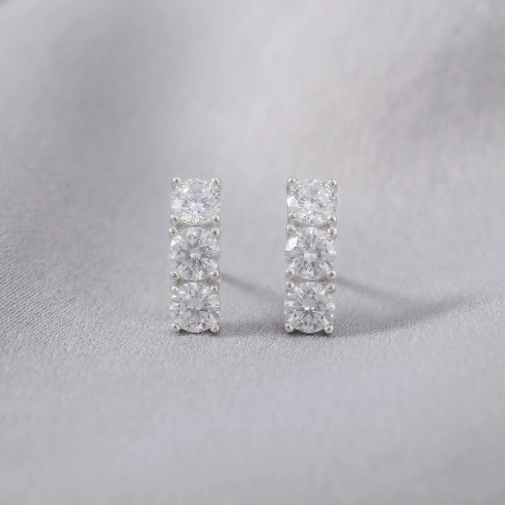 Pair of diamond stud earrings on a light gray background