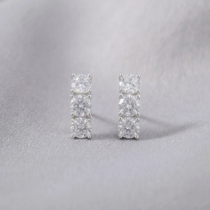 Pair of diamond stud earrings on a light gray background