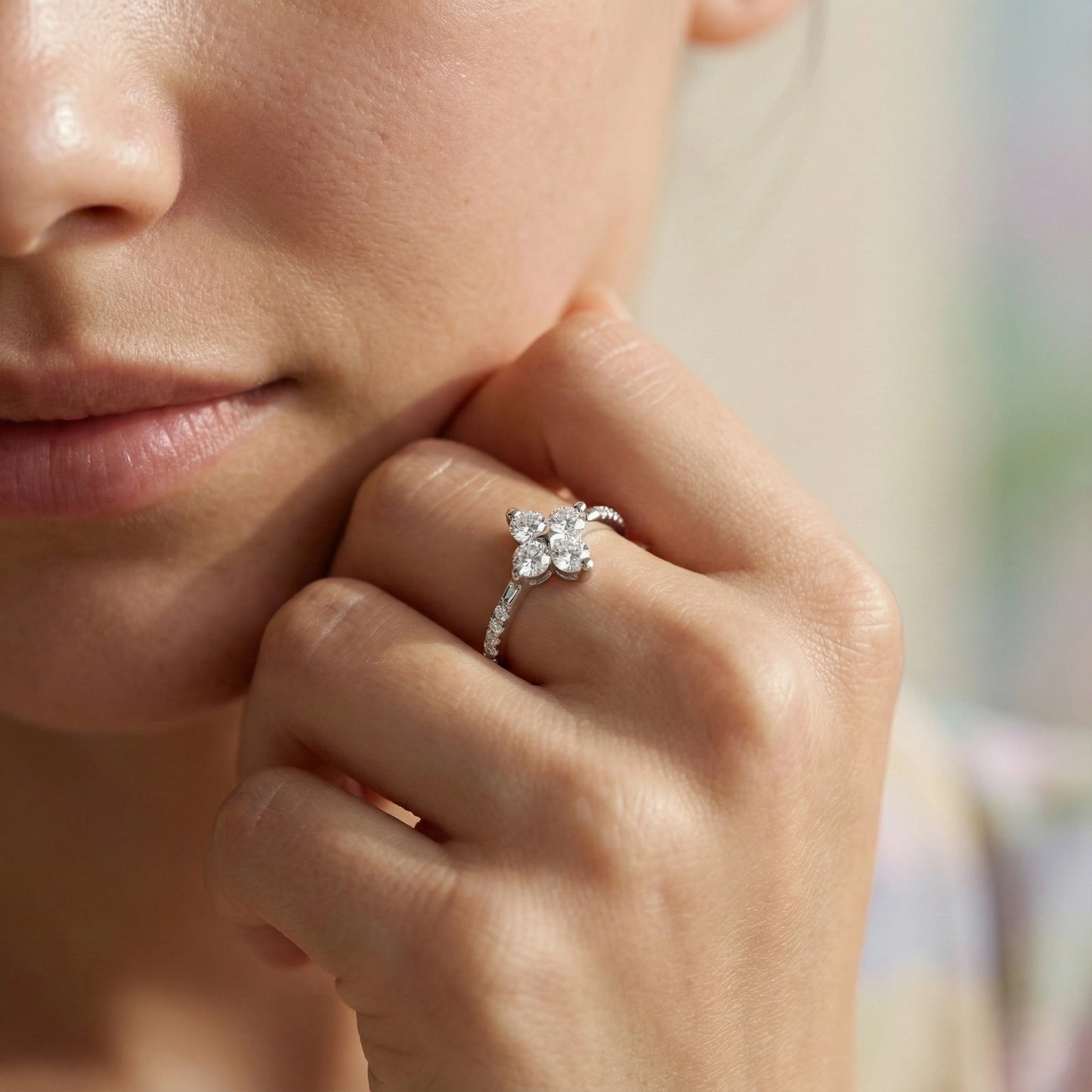 Close-up of a hand wearing a diamond ring with a blurred background