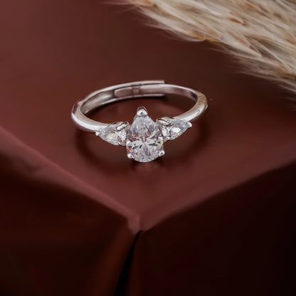 Silver ring with a diamond on a brown fabric background