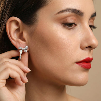 Close-up of a woman wearing a diamond earring with a neutral background