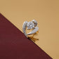 Silver ring with a large central gemstone on a brown fabric background